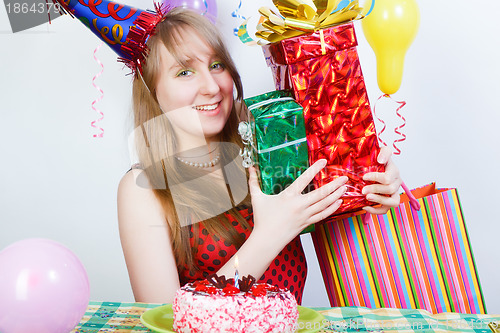 Image of Happy birthday. Attractive young girl with gifts