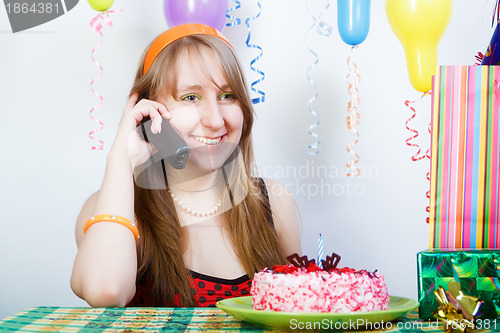 Image of Birthday of a young girl. telephone conversation