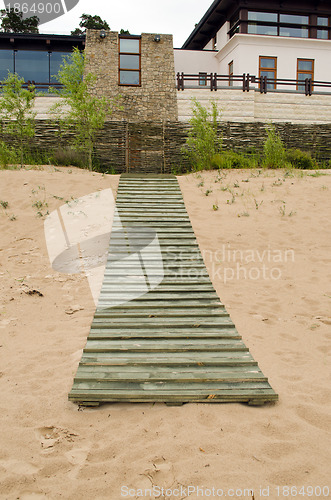 Image of Seaside wooden plank path house weaven fence 