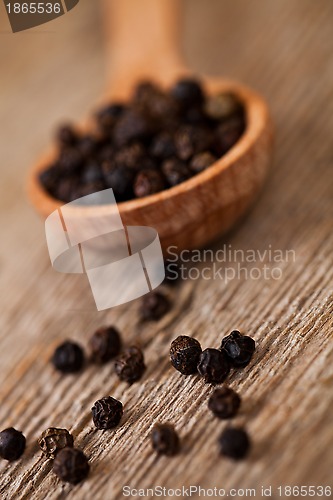 Image of black pepper in wooden 