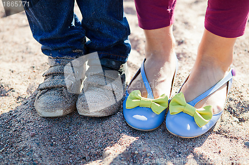 Image of Close-up of feet on beach.