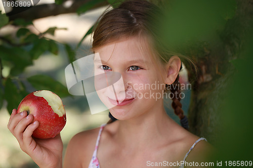 Image of Smiling girl eating an apple