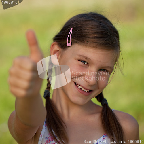 Image of Young girl showing thumbs up