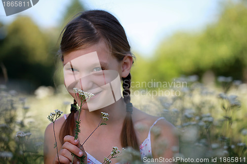 Image of Young girl holding a flower