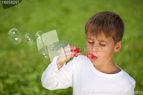 Image of Little boy having fun with bubbles