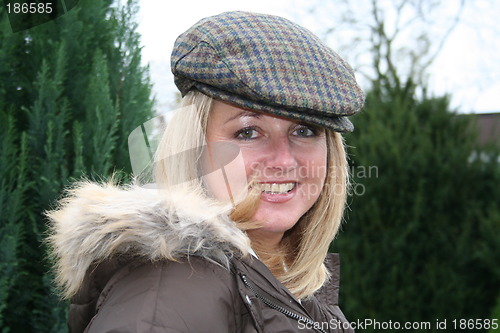 Image of Beauty in cap and jacket