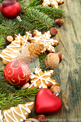 Image of Christmas toys, cookies and spruce branches.