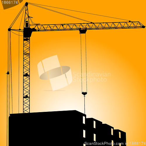 Image of Silhouette of crane on a sunset on a building