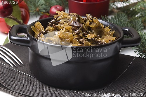 Image of traditional polish sauerkraut (bigos) with mushrooms and plums