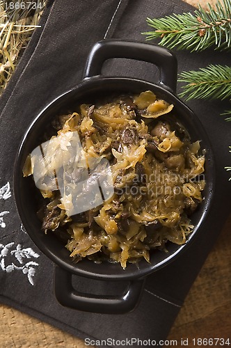 Image of traditional polish sauerkraut (bigos) with mushrooms and plums