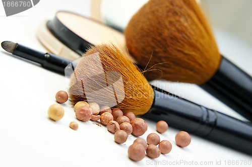 Image of Makeup foundation, powder, bronzer and brushes