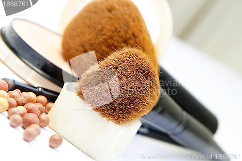 Image of Makeup foundation, powder, bronzer and brushes