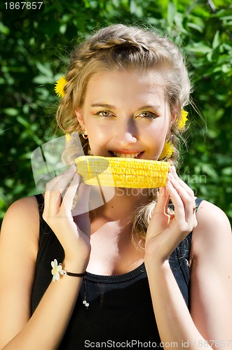 Image of woman eating corn-cob