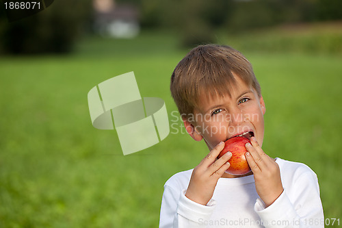 Image of Child eating an apple