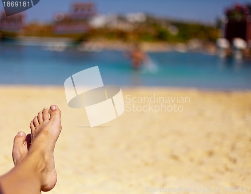 Image of sandy feet on the beautiful beach