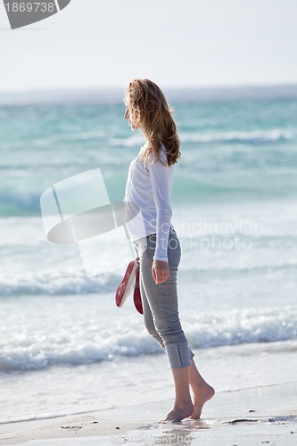 Image of beautiful young woman relaxing at beach in summer 