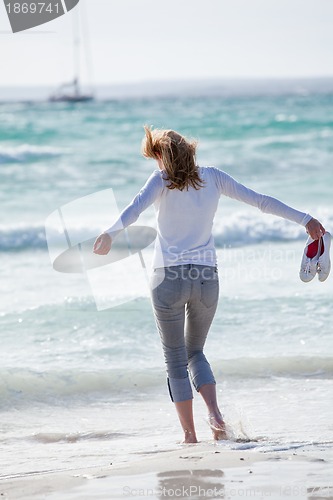 Image of beautiful young woman relaxing at beach in summer 