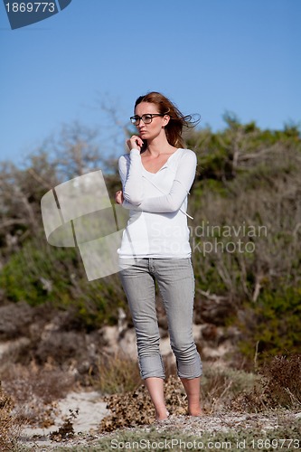 Image of beautiful woman relax in summer outdoor in wind dune beach