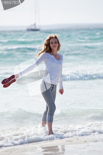 Image of beautiful young woman relaxing at beach in summer 