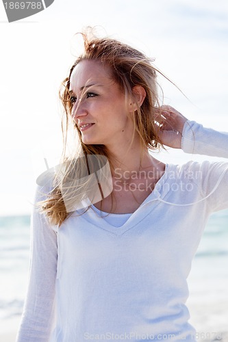 Image of beautiful young woman relaxing at beach in summer 