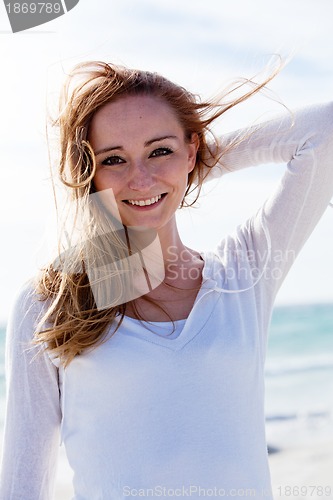 Image of beautiful young woman relaxing at beach in summer 