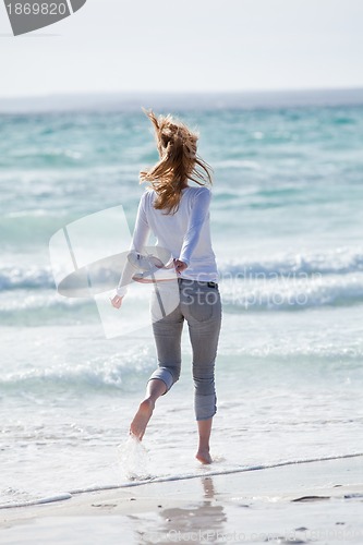 Image of beautiful young woman relaxing at beach in summer 
