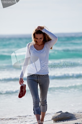 Image of beautiful young woman relaxing at beach in summer 