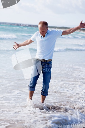 Image of young man is relaxing on beach in summer vacation