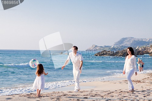 Image of happy young family with daughter on beach in summer