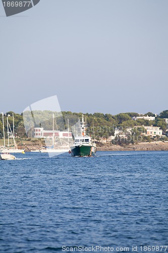 Image of fishing boat in summer outside in sea at harbour