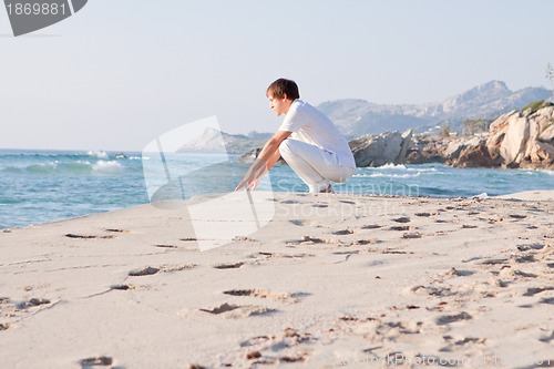 Image of young man is relaxing on beach in summer vacation