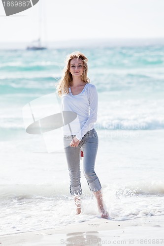 Image of beautiful young woman relaxing at beach in summer 