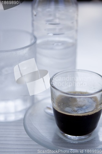 Image of hot aromatic espresso cup and cold water in glass