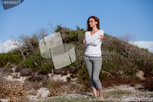 Image of beautiful woman relax in summer outdoor in wind dune beach