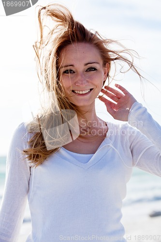 Image of beautiful young woman relaxing at beach in summer 