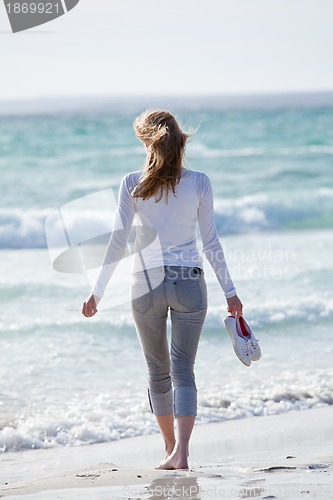 Image of beautiful young woman relaxing at beach in summer 