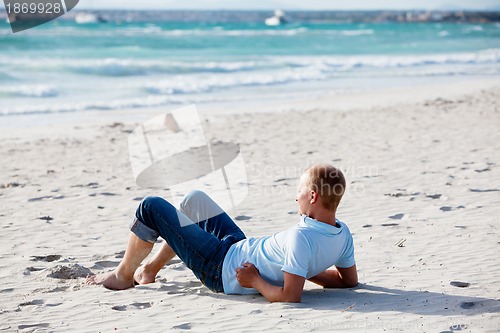 Image of young man is relaxing on beach in summer vacation