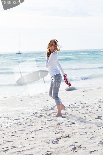 Image of beautiful young woman relaxing at beach in summer 
