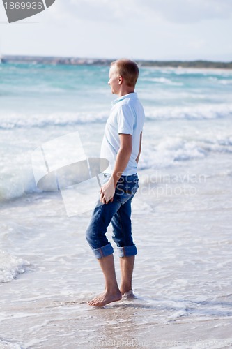 Image of young man is relaxing on beach in summer vacation