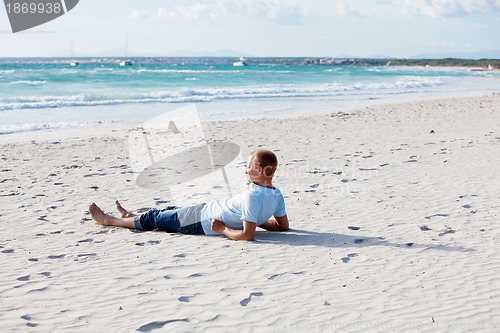 Image of young man is relaxing on beach in summer vacation