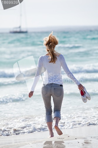 Image of beautiful young woman relaxing at beach in summer 
