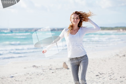 Image of beautiful young woman relaxing at beach in summer 