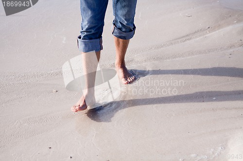 Image of barefoot in the sand in summer holidays relaxing