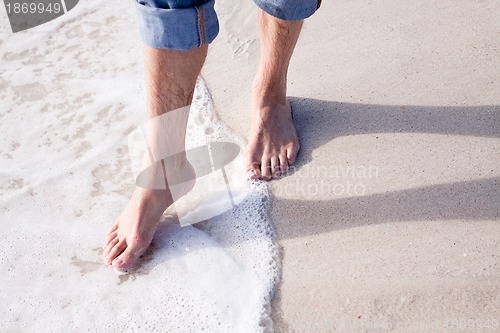 Image of barefoot in the sand in summer holidays relaxing