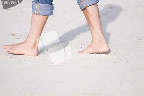 Image of barefoot in the sand in summer holidays relaxing