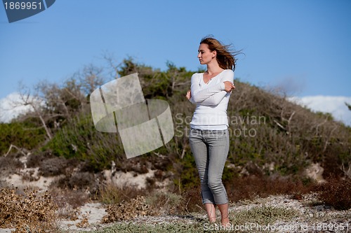 Image of beautiful woman relax in summer outdoor in wind dune beach