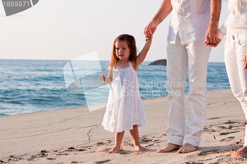 Image of happy young family with daughter on beach in summer