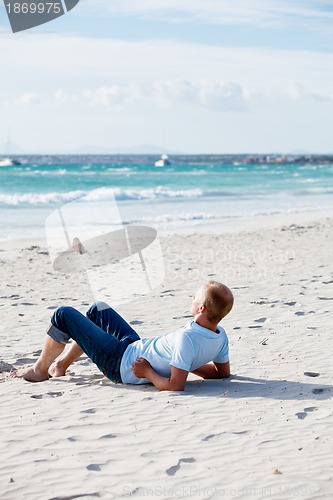 Image of young man is relaxing on beach in summer vacation
