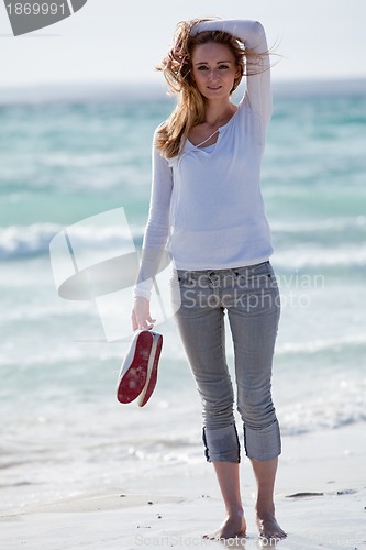 Image of beautiful young woman relaxing at beach in summer 