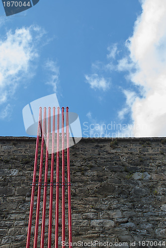 Image of Stone Wall With Red Pipes